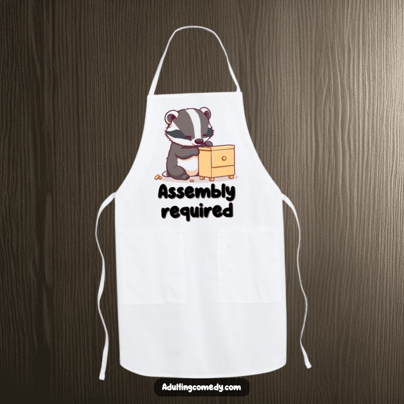 Funny badger apron featuring a busy animal carefully assembling a small, wobbly piece of furniture, a perfect funny kitchen gift.