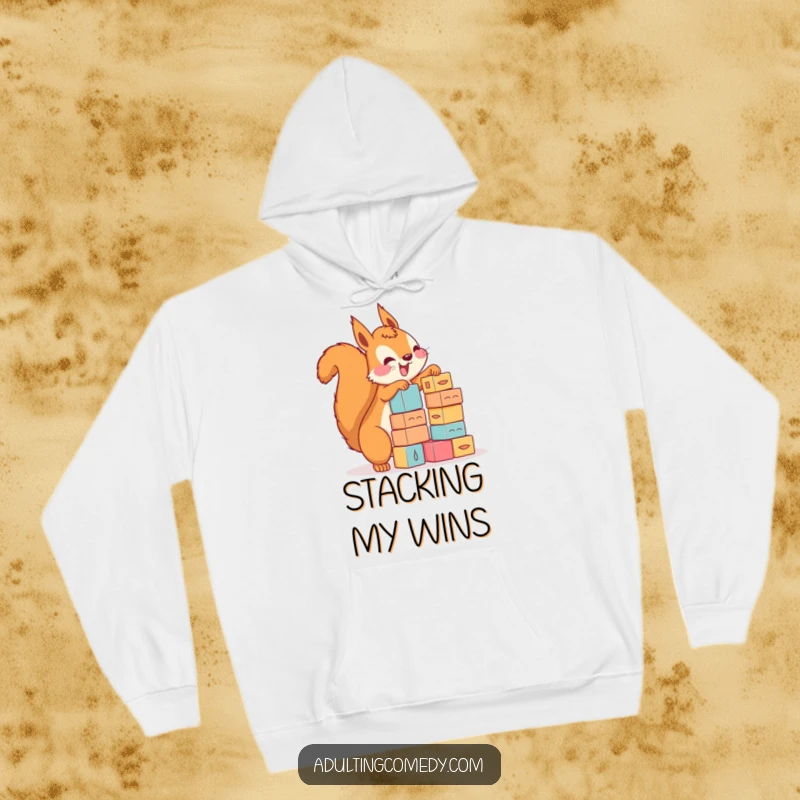 Funny squirrel hoodie featuring a happy creature stacking tiny blocks with comical, precarious enthusiasm, a great funny gift.